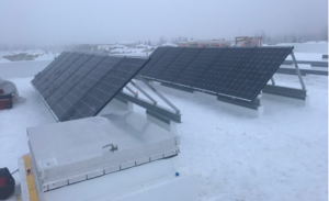 Solar panels on top of a building in the middle of winter. Done in Alaska by Vannoy Electric.